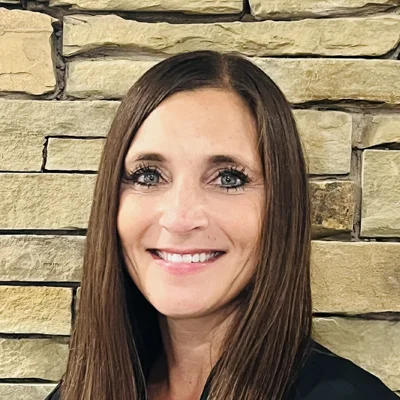 A headshot photo of Carrie